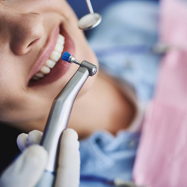 Woman in dental chair about to have teeth professionally cleaned