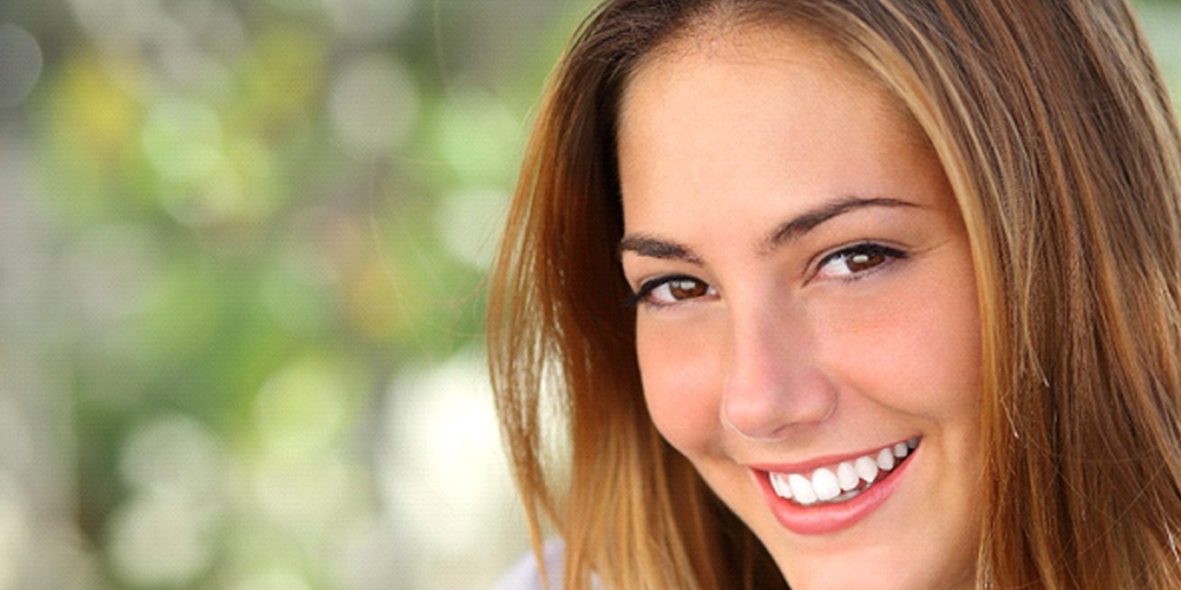 woman smiling with dental crowns in Burien