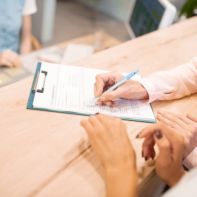 Patient filling out dental insurance forms