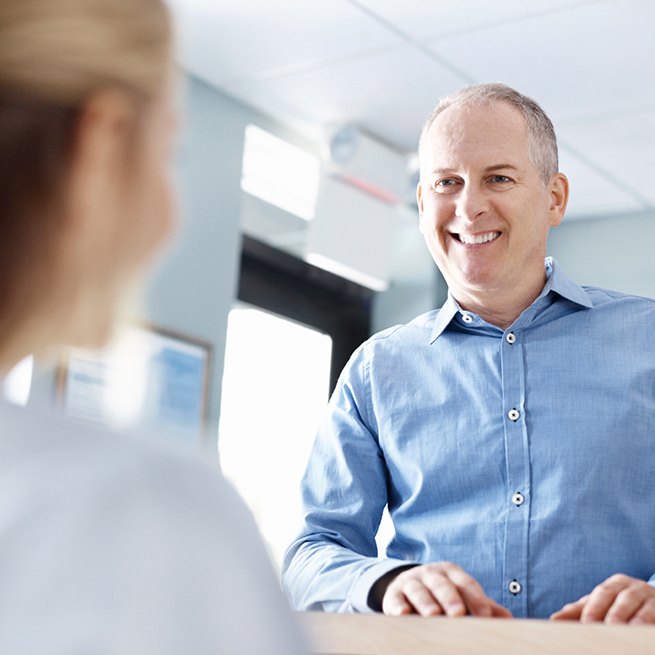 Dental patient checking in at front desk