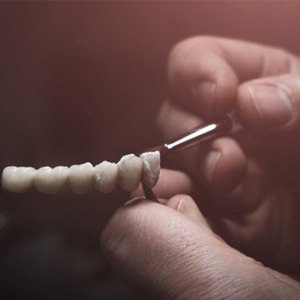 Lab technician painting teeth