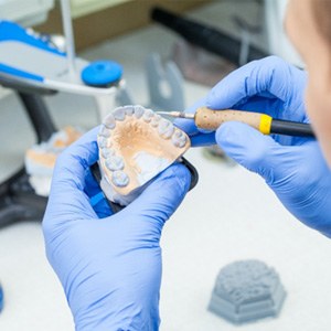Lab technician carving dentures