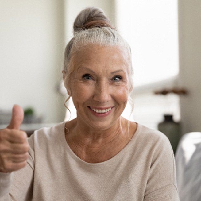smiling woman who understands the cost of dentures in Burien