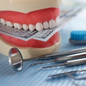 dentures with money and dental instruments (for Other Options for Affordable Dentures section)  