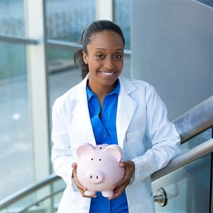 dental professional holding a piggy bank