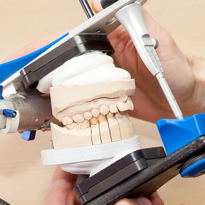 Dentist using equilibration system to plan jaw adjustment to treat T M J dysfunction