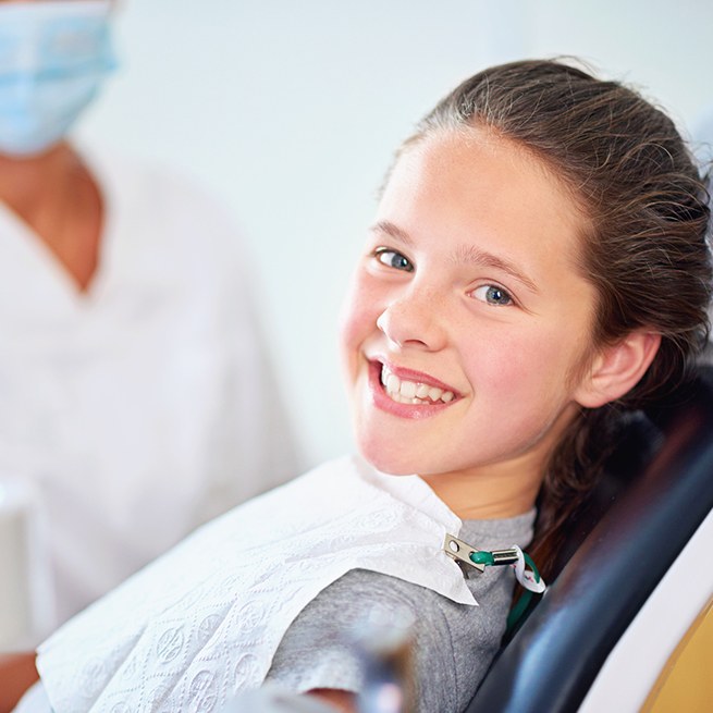 Young girl smiling during children's dentistry treatment