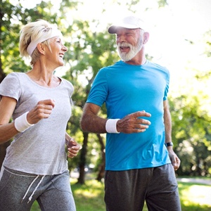 An older couple out running after receiving dental implants in Burien