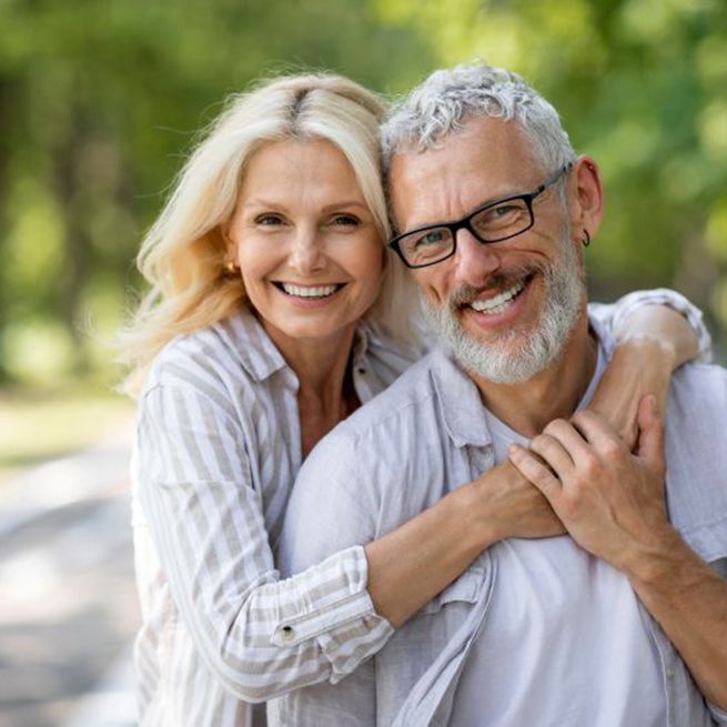 Senior couple embracing each other outdoors