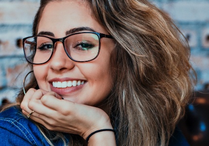 Smiling young woman with glasses