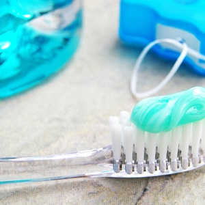 toothbrush, toothpaste, and floss for at-home hygiene