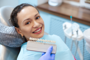 a patient smiling while receiving porcelain veneers