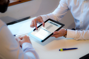 Showing a patient a dental insurance form on a tablet