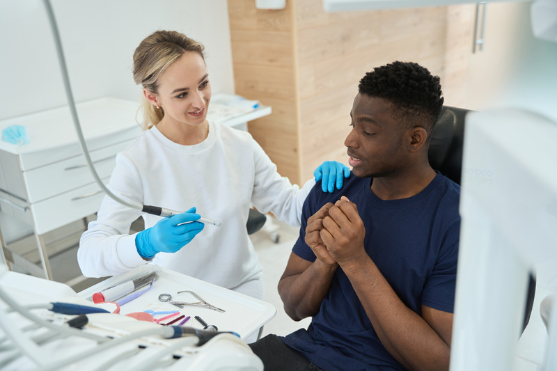 Patient needing tooth extraction comforted at dentist
