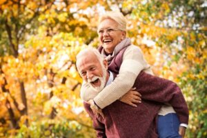 Couple with dentures smiling during the holidays