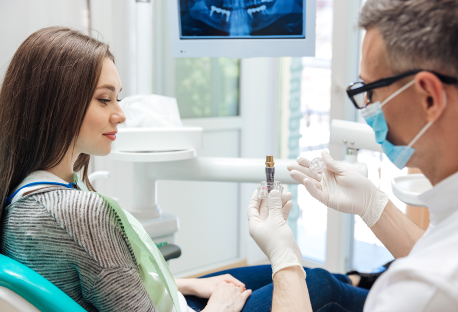 Dentist showing patient dental implant